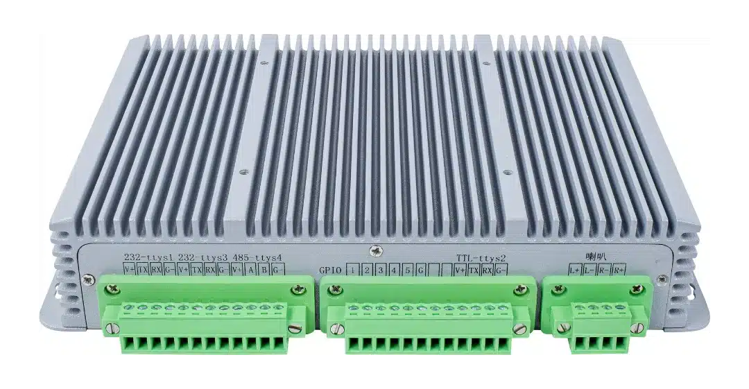 Rugged gray industrial controller with a large heatsink and three green terminal blocks at the front for wiring multiple channels.